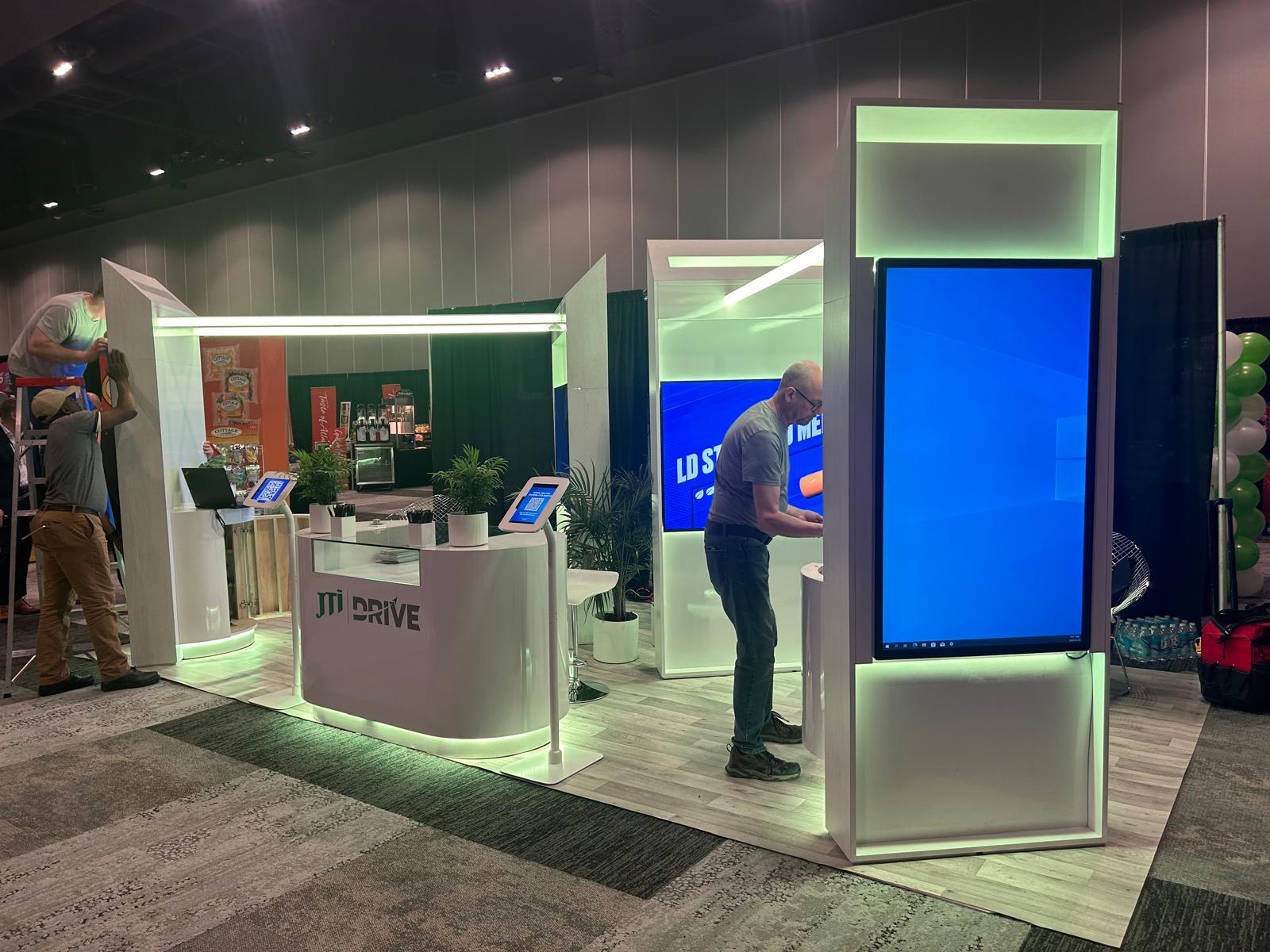 JTI trade show booth with illuminated displays