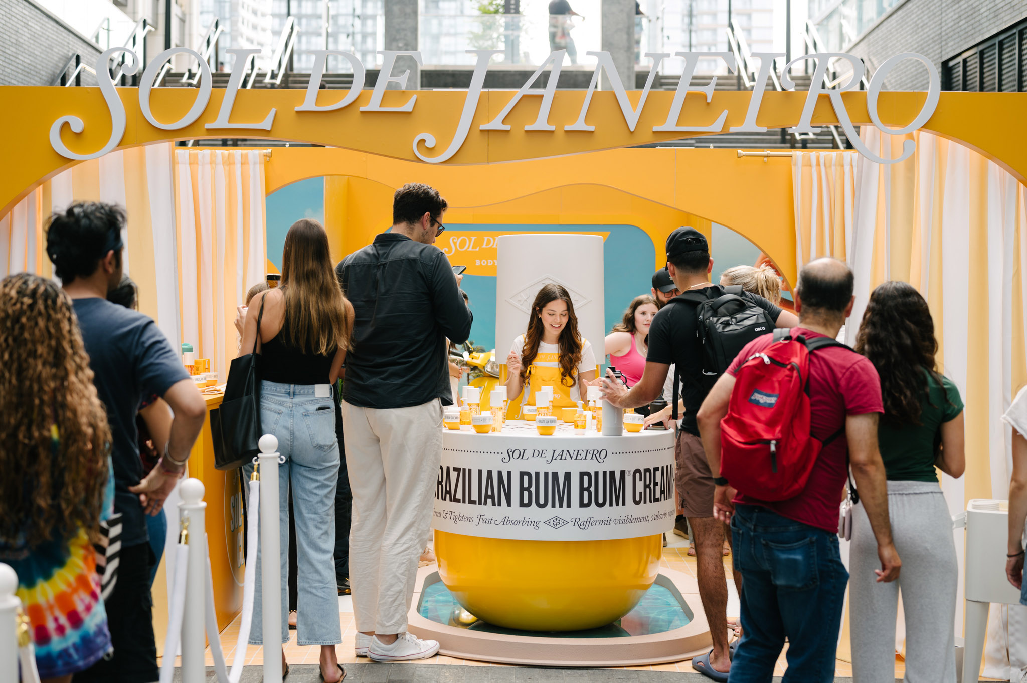 Sol de Janeiro yellow booth with visitors