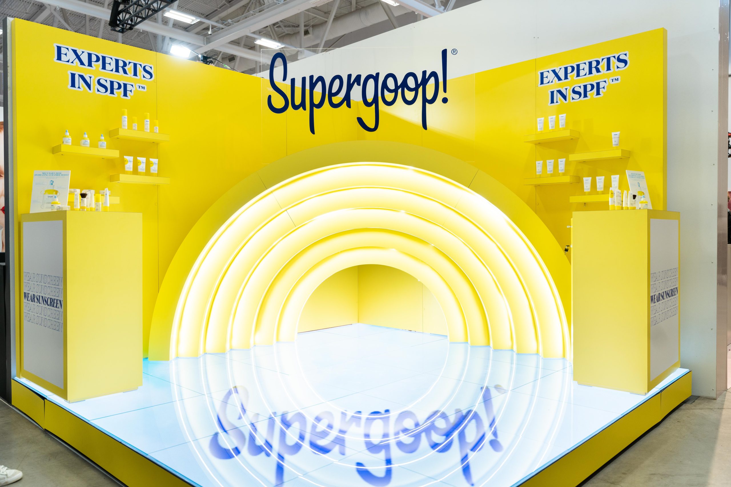 Supergoop yellow booth at Sephora brand fair